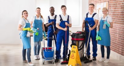 Portrait Of Happy Diverse Janitors In The Office With Cleaning Equipments